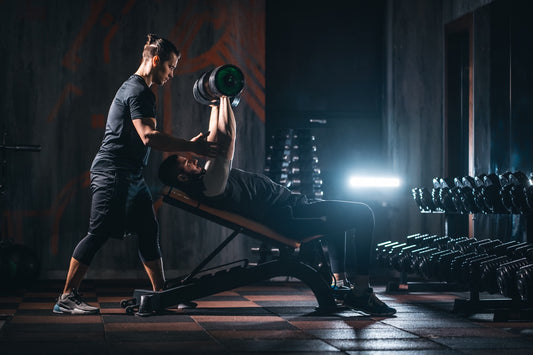 strength coach works with client