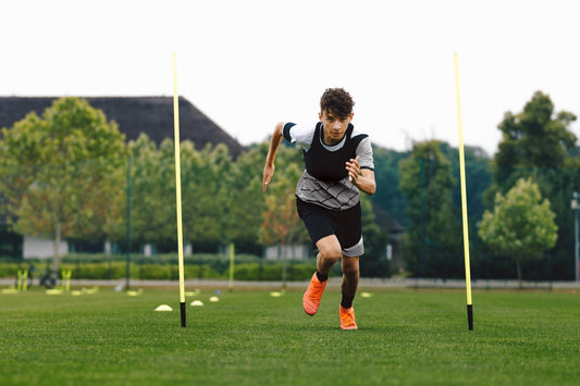 teenager doing agility training on soccer field
